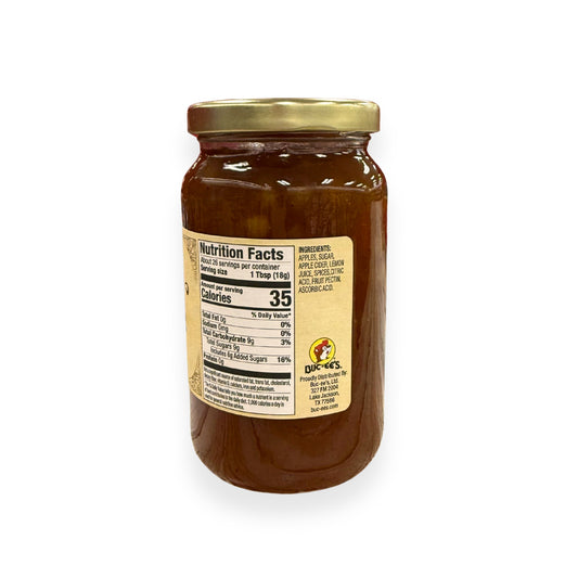 Buc-ee's Apple Cider Jam 17 oz mason jar side view showing nutrition facts label with 26 servings per container, ingredients list including apples, apple cider, and spices, and golden vintage-style labeling