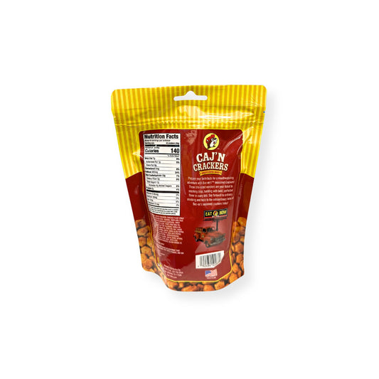 Buc-ee's Caj'N Crackers 6 oz yellow and red pouch back view showing detailed nutrition facts label with 140 calories per serving and Cajun cracker product information