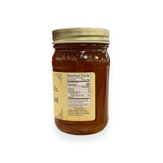 Buc-ee's Cinnamon Pear Preserves 17.5 oz mason jar side view showing nutrition facts label with 25 servings per container, ingredients list including pears and natural cinnamon flavor, and golden vintage-style labeling