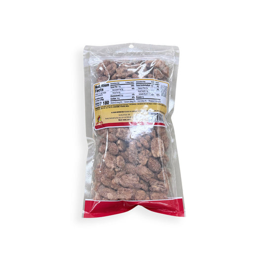Buc-ee's Cinnamon Pecans 12 oz clear plastic bag back view showing detailed nutrition facts label with 180 calories per serving and ingredient information