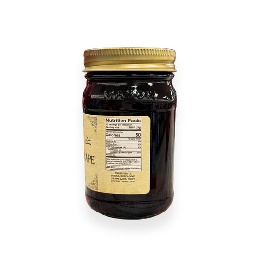 Buc-ee's Muscadine Grape Jelly 17.5 oz mason jar side view showing detailed nutrition facts label, ingredients list including muscadine grape juice, and golden vintage-style labeling