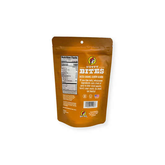 Buc-ee's Nutty Bites Salted Caramel Cashew Almond 4 oz golden brown pouch back view showing detailed nutrition facts label with 160 calories per serving and wholesome ingredient information with "Get Nutty" messaging