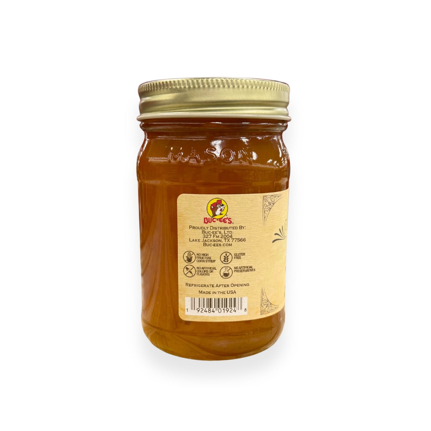 Buc-ee's Peach Preserves 17.5 oz mason jar back view showing Buc-ee's distributor information from Lake Jackson TX, gluten-free certification, no artificial preservatives badges, barcode, and storage instructions