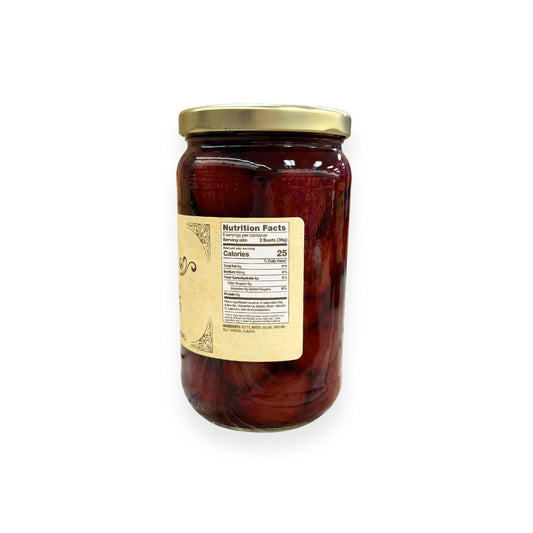 Buc-ee's Pickled Beets 16 fl oz glass jar side view showing nutrition facts label, deep ruby red beet slices in clear pickling brine, and golden yellow vintage-style labeling