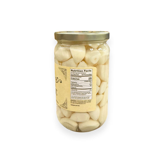 Buc-ee's Pickled Garlic 16 fl oz glass jar side view showing nutrition facts label, whole white garlic cloves in clear brine, and golden yellow vintage-style labeling