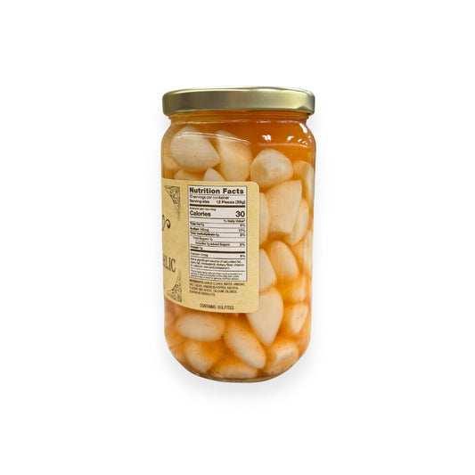 Buc-ee's Pickled Habanero Garlic 16 fl oz glass jar side view showing nutrition facts label, white habanero peppers and garlic cloves in amber brine, and golden yellow vintage-style labeling