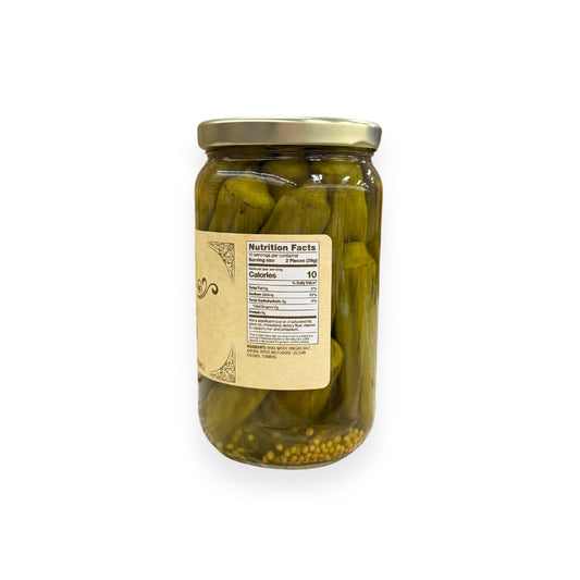 Buc-ee's Pickled Okra 16 fl oz glass jar side view showing nutrition facts label, crisp green okra pods in clear brine with seeds visible at bottom, and golden yellow vintage-style labeling