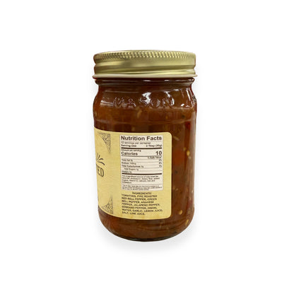 Buc-ee's 5-Fire Roasted Pepper Salsa 14 oz mason jar side view showing nutrition facts label with 12 servings per container, ingredients list including fire roasted peppers and multiple pepper varieties, and golden vintage-style labeling