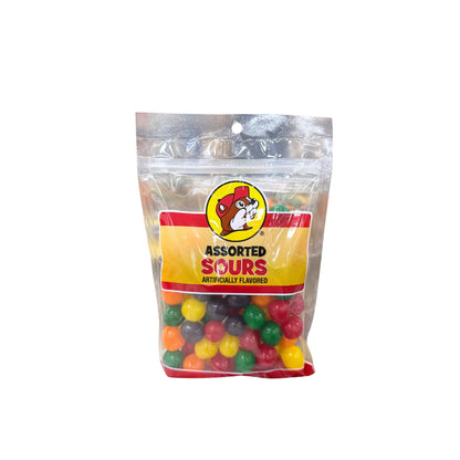 Buc-ee's assorted sours candy bag showing colorful multi-colored sour fruit-flavored balls with Bucky logo on yellow and red label