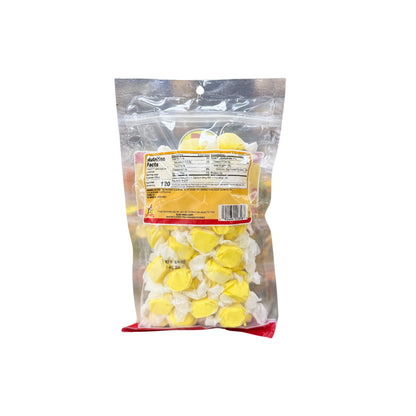 Buc-ee's banana taffy bag back showing nutrition facts and yellow individually wrapped taffy candies in resealable packaging