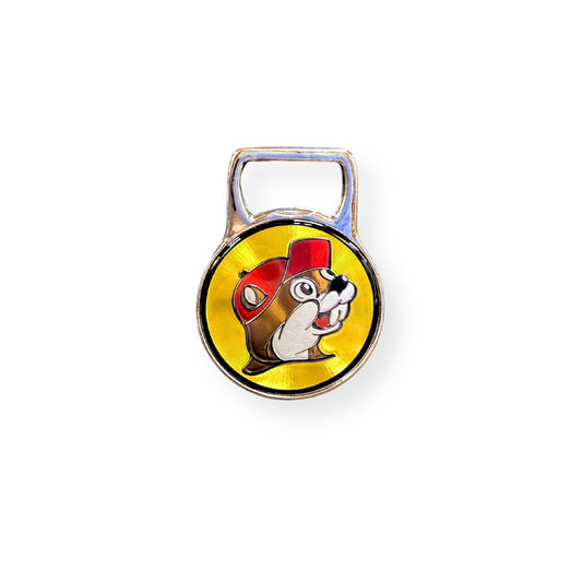 Buc-ee's chrome bottle opener magnet featuring iconic smiling Bucky beaver character on bright yellow circular background with red cap detail