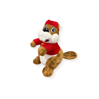 Front view of Buc-ee's beaver plush showing friendly expression, prominent white teeth, red shirt with logo, and white puffy cheeks