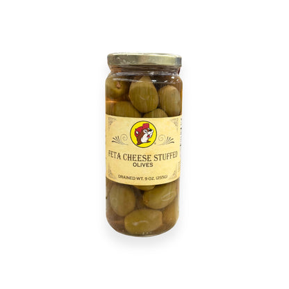 Buc-ee's Feta Cheese Stuffed Olives 9 oz glass jar front view featuring iconic red beaver mascot logo, ornate vintage-style label design, and clear view of feta-stuffed green olives