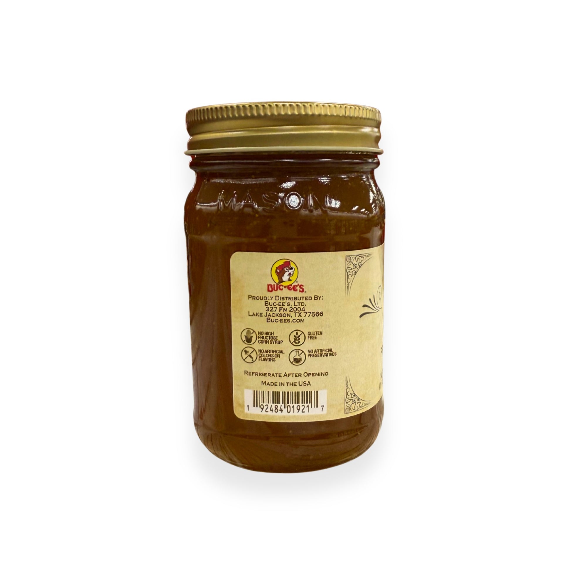 Buc-ee's Fig Preserves 17.5 oz mason jar back view showing Buc-ee's distributor information from Lake Jackson TX, gluten-free certification, no artificial preservatives badges, barcode, and storage instructions