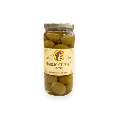Buc-ee's Garlic Stuffed Olives 9 oz glass jar front view featuring iconic red beaver mascot logo, ornate vintage-style label design, and clear view of garlic-stuffed green olives