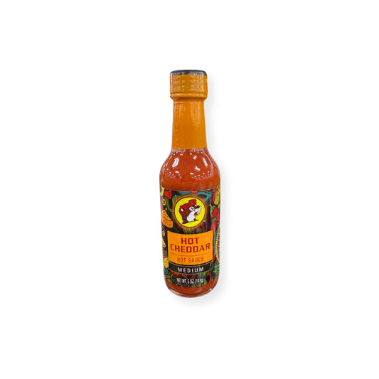 Buc-ee's Hot Cheddar Hot Sauce 5 oz bottle front view featuring orange bottle cap with beaver mascot logo, "HOT CHEDDAR HOT SAUCE" text, "MEDIUM" heat designation, and vibrant cheese-themed label graphics