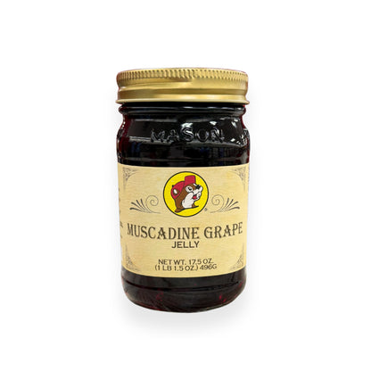Buc-ee's Muscadine Grape Jelly 17.5 oz mason jar front view featuring iconic red beaver mascot logo, "MUSCADINE GRAPE JELLY" text, and classic mason jar styling with golden lid
