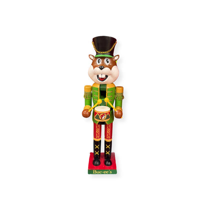 Buc-ee's 2024 limited edition nutcracker beaver standing 16 inches tall in elaborate military uniform with green and gold jacket, red pants, black boots, tall hat with gold chain, and decorative drum
