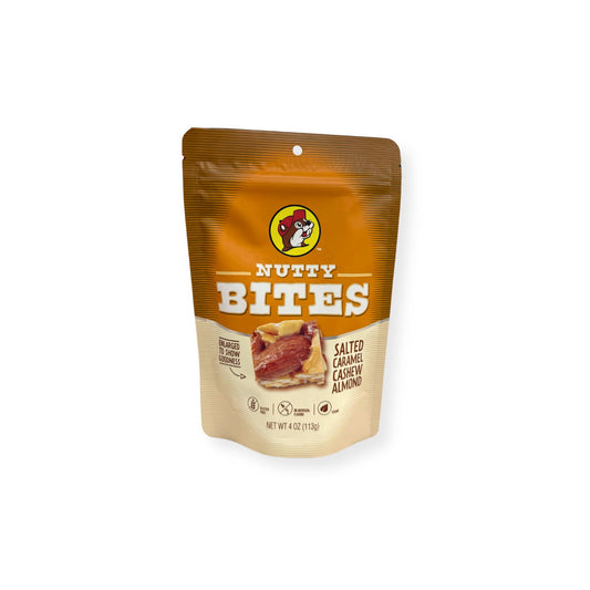 Buc-ee's Nutty Bites Salted Caramel Cashew Almond 4 oz golden brown and cream pouch front view featuring iconic red beaver mascot logo, "NUTTY BITES" text, "SALTED CARAMEL CASHEW ALMOND" description, and enlarged product image showing goodness