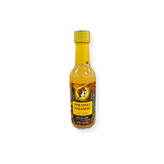 Buc-ee's Pineapple Habanero Hot Sauce 5 oz bottle front view featuring yellow bottle cap with beaver mascot logo, "PINEAPPLE HABANERO HOT SAUCE" text, "MEDIUM" heat designation, and vibrant tropical pineapple-themed label graphics