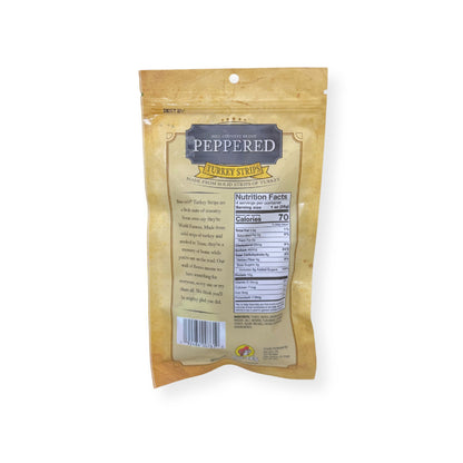 Buc-ee's Hill Country Brand Peppered Turkey Strips 4oz package back showing nutrition facts label, product description, and barcode with golden yellow packaging