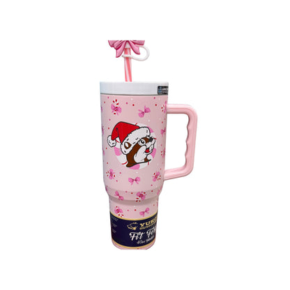 Buc-ee's 2025 pink bow tumbler showing Santa Bucky design with Christmas hat on soft pink background with bows and flowers, 40oz stainless steel