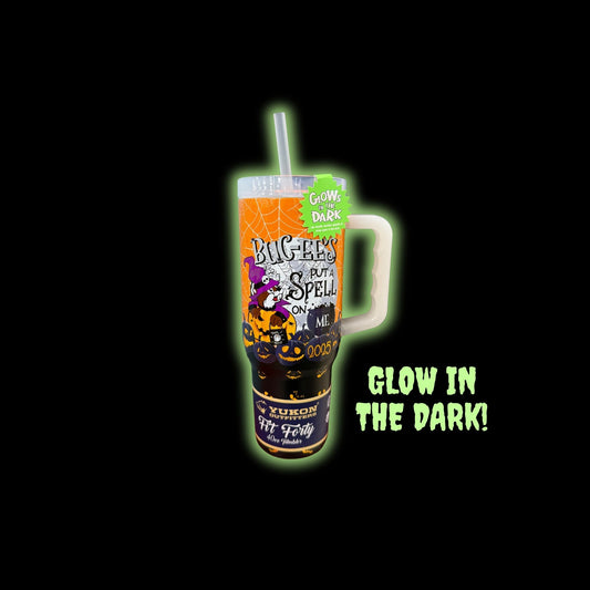 Halloween tumbler glowing bright green in darkness demonstrating glow-in-the-dark feature with 'GLOW IN THE DARK!' text