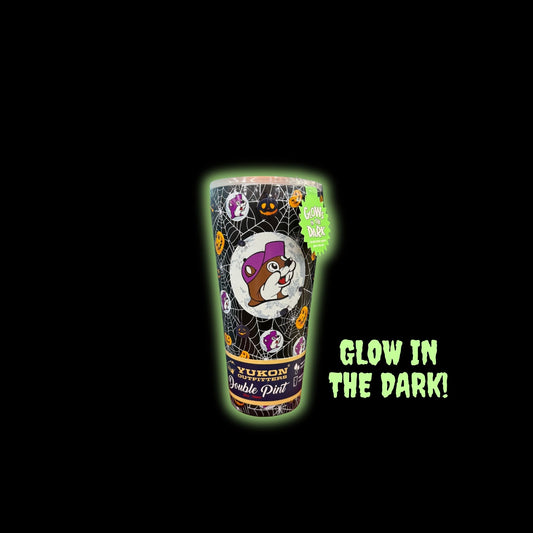 Halloween Double Pint cup glowing bright green in darkness demonstrating glow-in-the-dark feature with 'GLOW IN THE DARK!' text