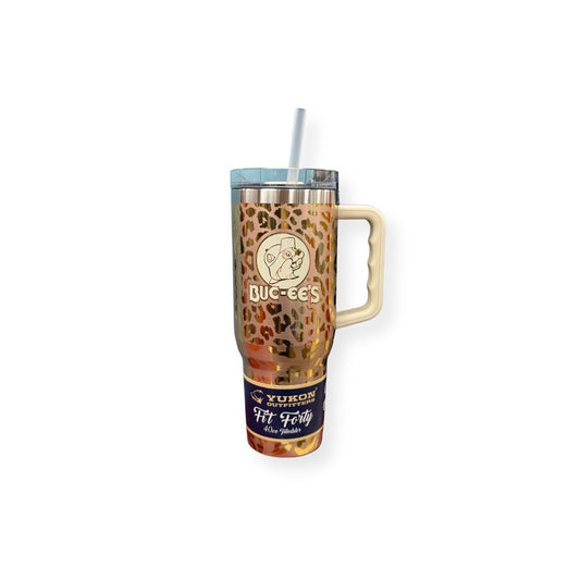 Yukon Outfitters 40oz leopard print tumbler with cream handle and clear straw featuring Buc-ee's beaver logo on brown and orange animal print pattern